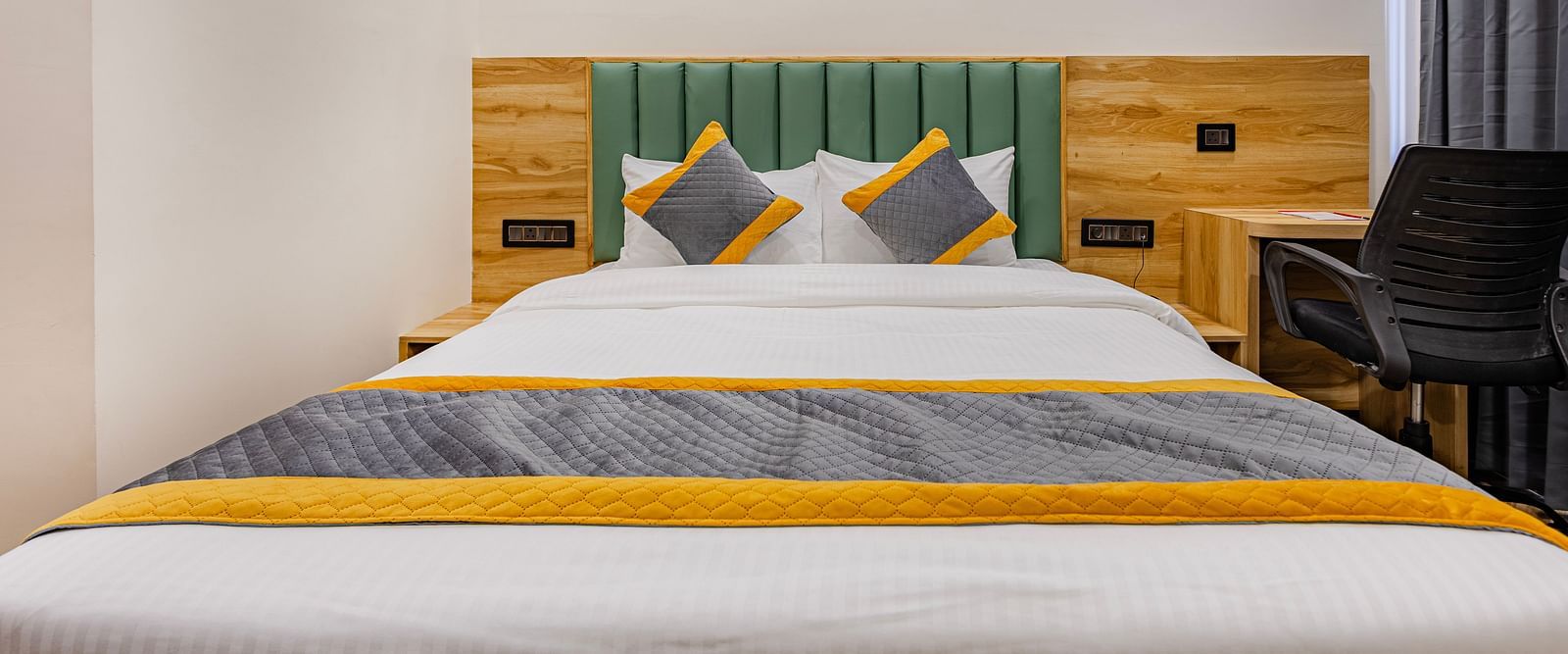 Lemonridge Hotels, KPHB | Lemon Ridge Hotels, KPHB: Hotel room with a double bed, headboard, and artwork on the wall. Clean and simple design.